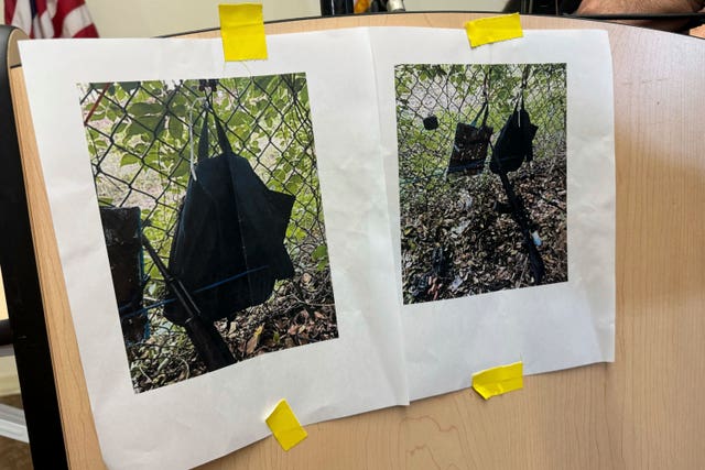 Photos showing an AK-47 rifle, a backpack and a Go-Pro camera on a fence outside the Trump International Golf Club, taken after an apparent assassination attempt on Republican presidential candidate Donald Trump, are shown during a press conference at the Palm Beach County Main Library in West Palm Beach, Florida.