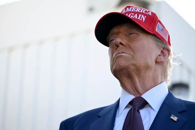 A close-up of Donald Trump in a red baseball cap