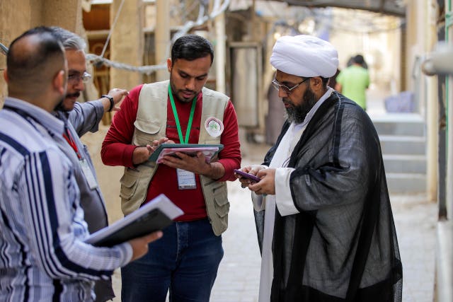 Workers prepare to collect information from the public
