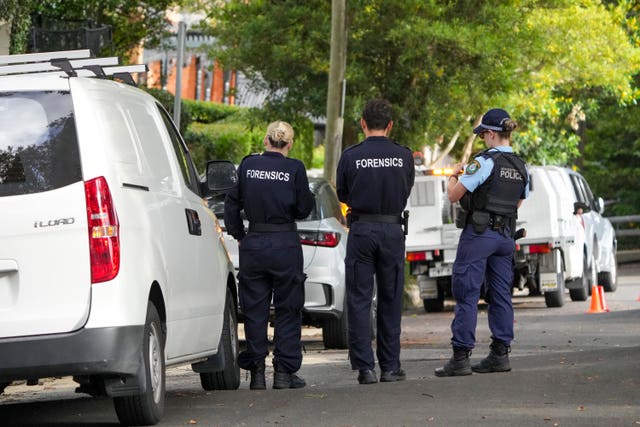 Police stand outside houses
