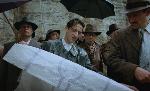 Adrien Brody, centre, in a scene from The Brutalist
