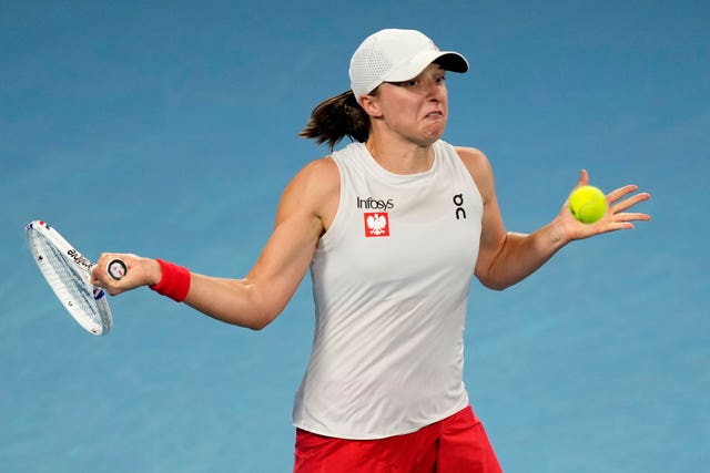 Iga Swiatek prepares to strike a forehand