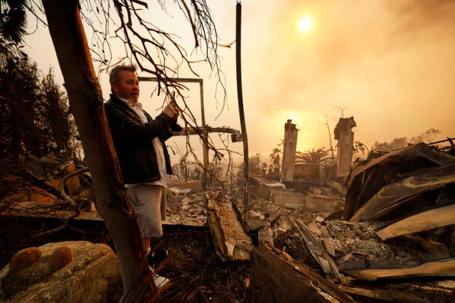 Kelly Kline looks out at his home damaged by the Palisades fire in Malibu
