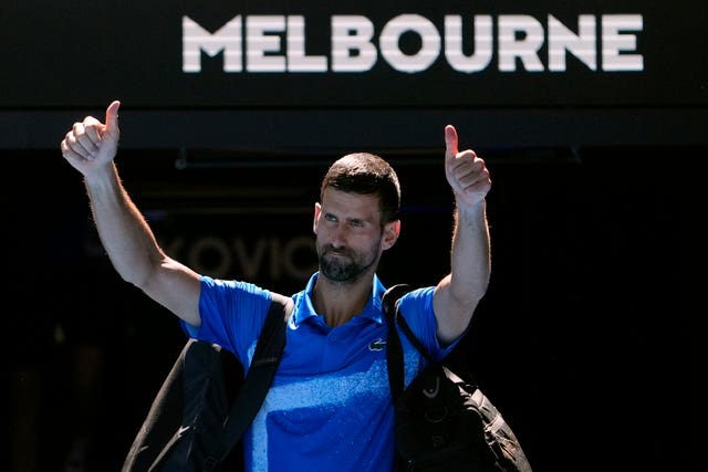 Novak Djokovic gestures as he leaves Rod Laver Arena after retiring
