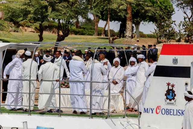 People surround the coffin of Prince Karim Al-Hussaini, the Aga Khan IV and 49th hereditary imam of the Shiite Ismaili Muslims, who died Tuesday in Portugal, to be buried at the Aga Khan mausoleum in Aswan, Egypt