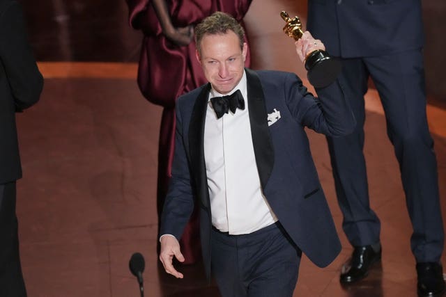 Lol Crawley accepts the Oscar for best cinematography for The Brutalist
