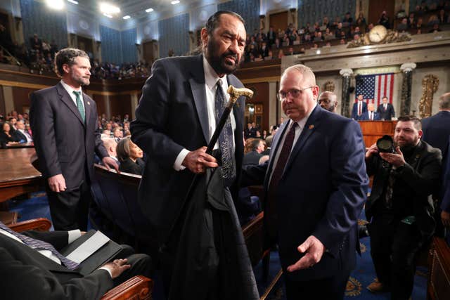 Democrat Representative Al Green is removed from the chamber as President Donald Trump speaks