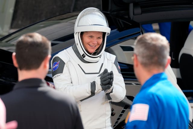 Astronaut Anne McClain greets friends and family before lift off