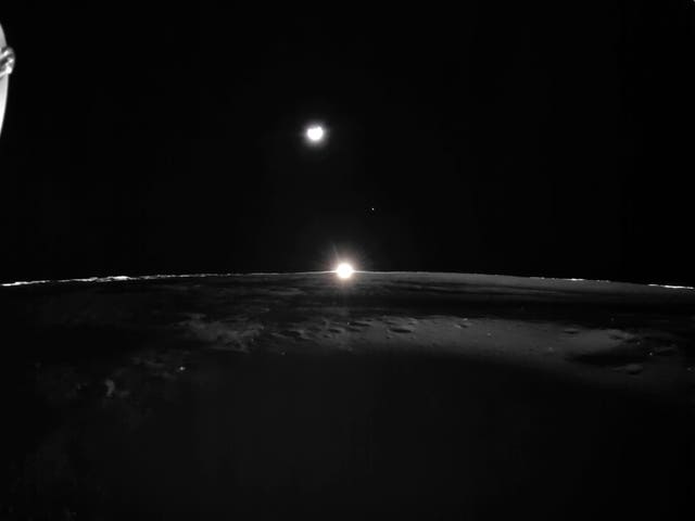 The sun setting on the Moon, with Earth and Venus in the distance