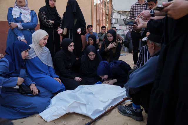 Palestinians mourn over the body of Kinan Edwan, two, killed in an Israeli army airstrike