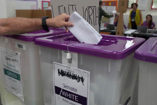 A ballot is dropped into a box in Sydney