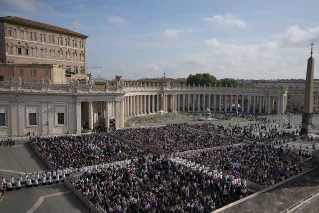 People gather in St Peter’s Square as they await the arrival of the body of Pope Francis, which will lie in state at St Peter’s Basilica for three days, at the Vatican