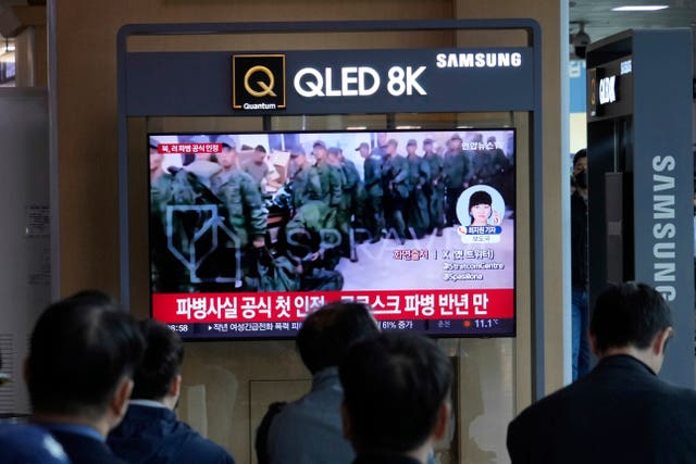 A TV screen shows a file image of soldiers believed to be from North Korea standing in line to receive supplies from Russia, during a news programme at Seoul railway station in South Korea