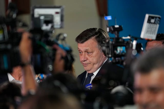 Presidential candidate Crin Antonescu speaks to media during a meeting with supporters after polls closed