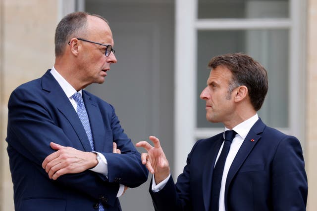 German Chancellor Friedrich Merz, left, talks to French President Emmanuel Macron