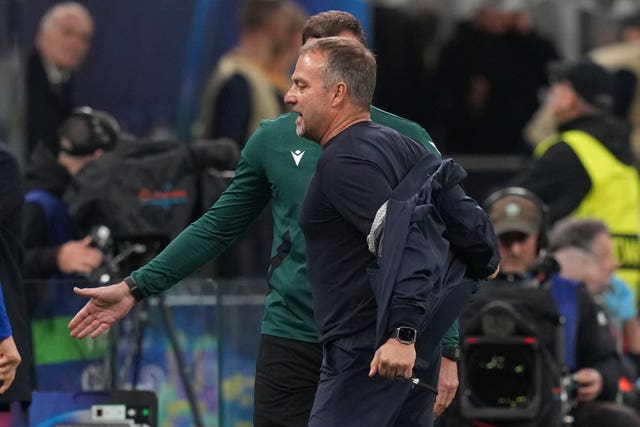 Hansi Flick takes off his jacket as he argues with the fourth official