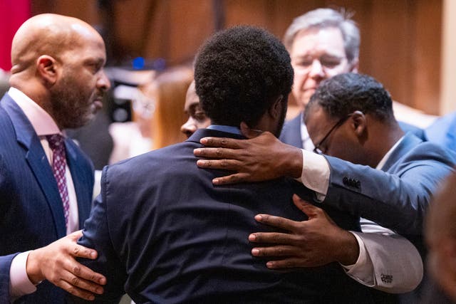 Former Memphis Police Department officers Demetrius Haley, centre, Tadarrius Bean, left, and Justin Smith Jr hug each other in court