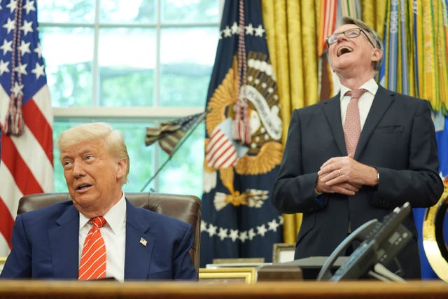 Donald Trump, left, gets a reaction from UK ambassador to the United States Peter Mandelson, right