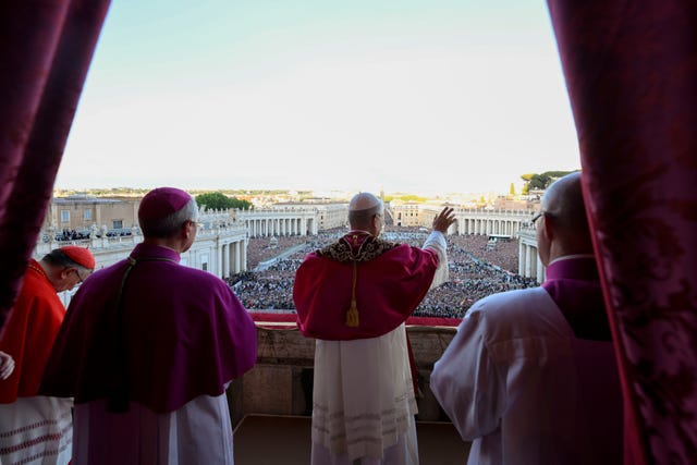 Newly elected Pope Leo XIV waves to faithful and pilgrims gathered in St Peter’s Square at the Vatican shortly after his election