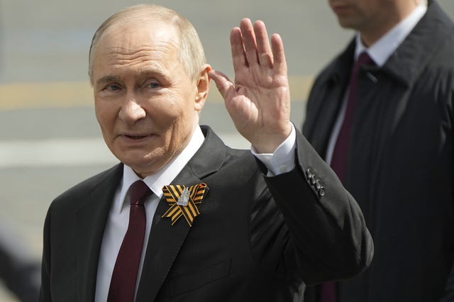 Vladimir Putin waves