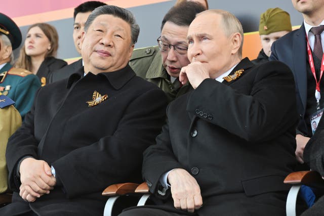 Russian President Vladimir Putin, right, and Chinese President Xi Jinpin watch the Victory Day military parade