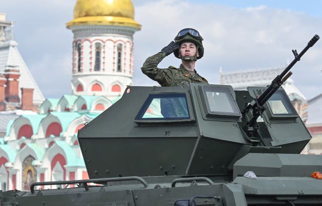 A Russian solder saluting from a tank in Red Square