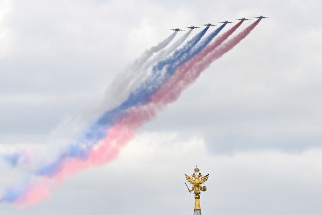 Russian Air Force Su-25 jets flying with coloured smoke coming from them to make out the Russian flag