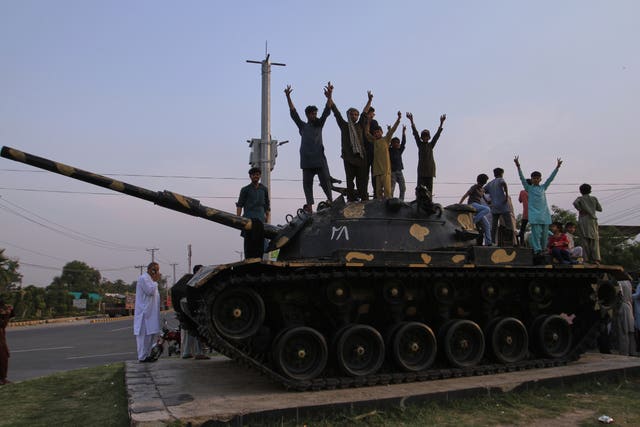 People standing on top of a model tank