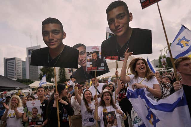 People gather to watch a live broadcast of Israeli-American soldier Edan Alexander being released