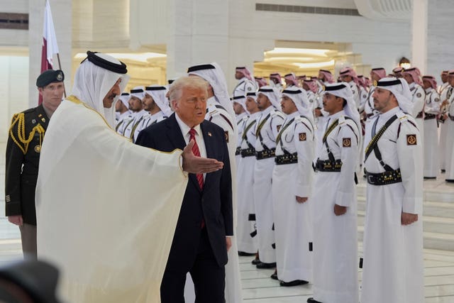 Qatar’s Emir Sheikh Tamim bin Hamad Al Thani welcomes US President Donald Trump during an official welcoming ceremony at the Amiri Diwan in Doha, Qatar