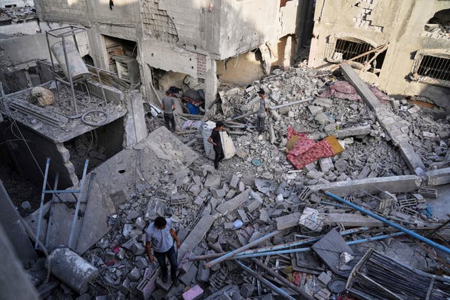 Palestinians inspect the rubble of homes destroyed by Israeli air strikes in Jabaliya, northern Gaza Strip