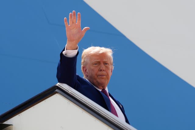 US president Donald Trump waves as he boards Air Force One