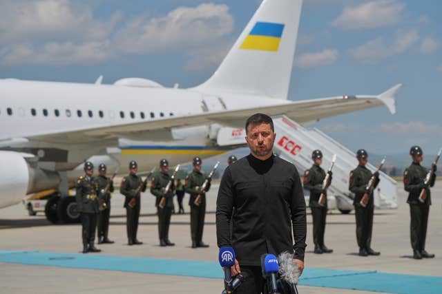Ukrainian President Volodymyr Zelensky talks to journalists as he arrives at Esenboga airport in Ankara, Turkey