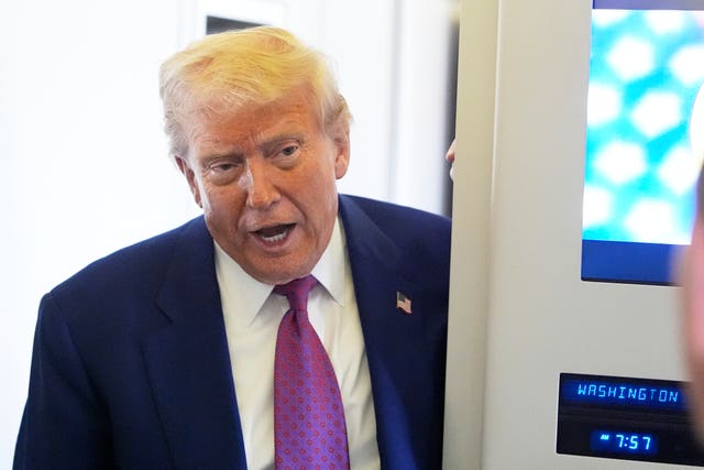 President Donald Trump speaks to media on board Air Force One