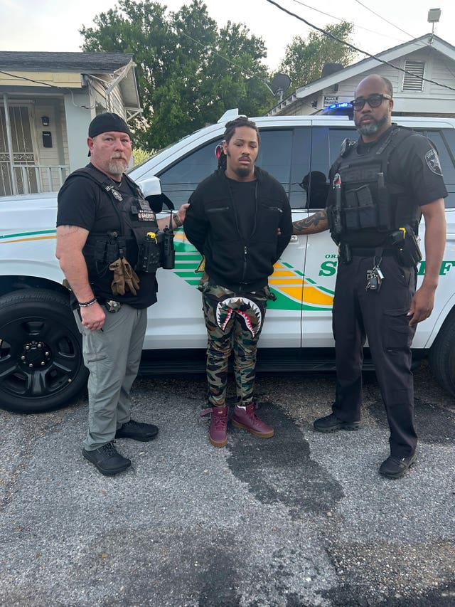 Escapee Robert Moody flanked by Detective Charles Morgan, left, and Detective Bryant Parish, right, after he had been captured in New Orleans on Friday