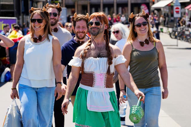 Eurovision fans walk in the city center ahead of the Grand Final of the 69th Eurovision Song Contest in Basel, Switzerland