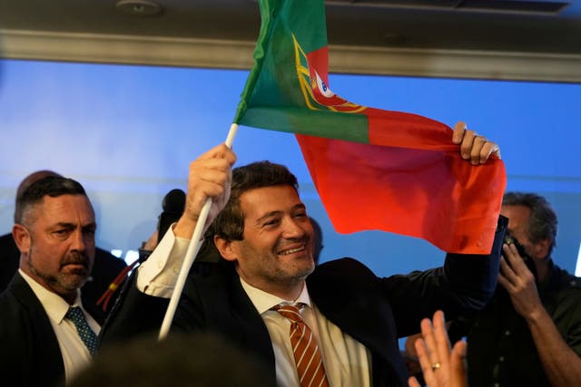 Chega leaders celebrate under a Portuguese flag