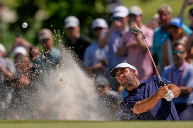 Scottie Scheffler hits out of a bunker