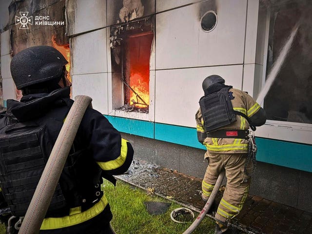 Firefighters put out a blaze following a Russian drone attack in the Kyiv region