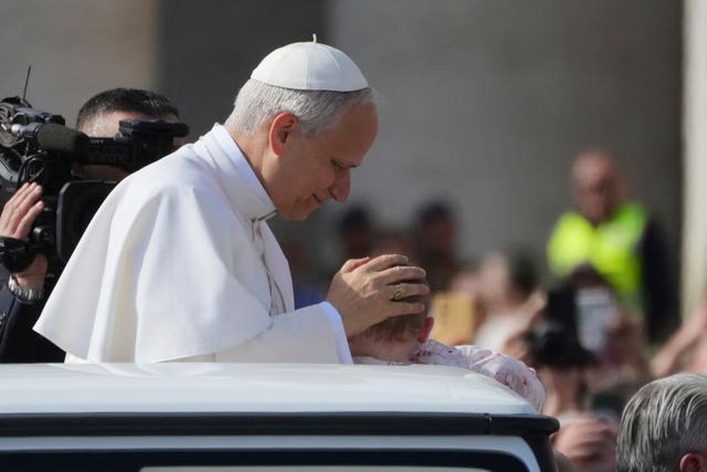 Pope Leo XIV blesses a child