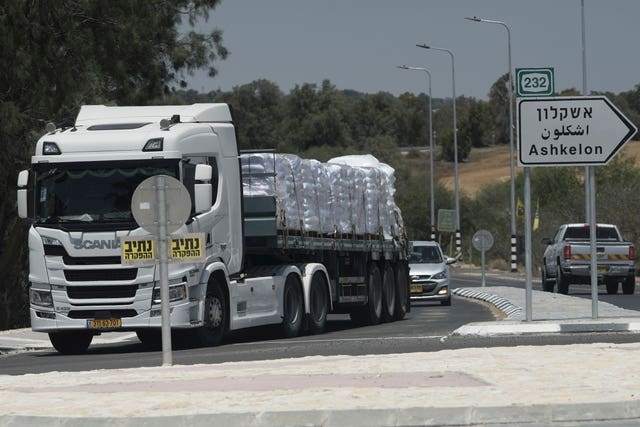 A truck loaded with humanitarian aid makes its way to the Kerem Shalom crossing