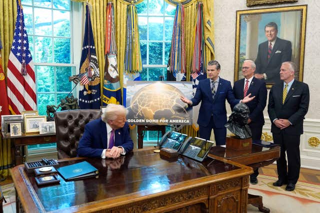 US President Donald Trump, Sen Dan Sullivan, right, and Sen Kevin Cramer, listen as US Defence Secretary Pete Hegseth speaks in the Oval Office