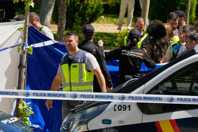 Members of the judicial police at the scene after an adviser to former Ukrainian president Viktor Yanukovych was shot outside a school in Madrid, Spain