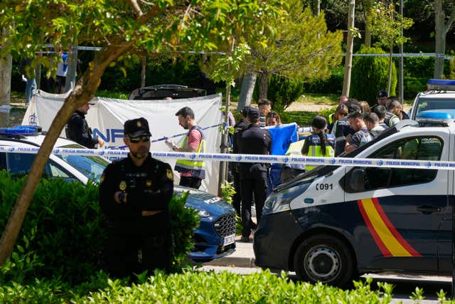 Members of the judicial police at the scene after an adviser to former Ukrainian president Viktor Yanukovych was shot outside a school in Madrid, Spain