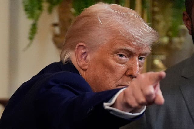 President Donald Trump gestures as he departs after hosting the 2025 NCAA Champion, University of Florida men’s basketball team in the East Room of the White House