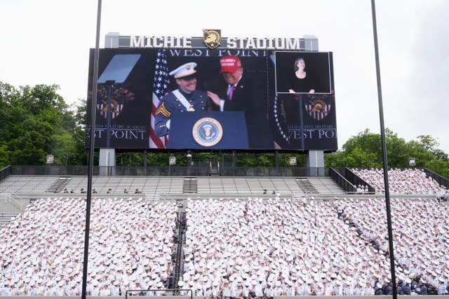 Graduating cadet Chris Verdugo is pictured on screen alongside President Donald Trump