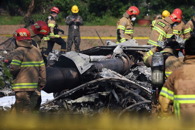 South Korean firefighters and military officers at the scene of a South Korean navy plane’s crash in Pohang