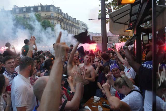 Supporters celebrate a PSG goal outside a cafe in Paris