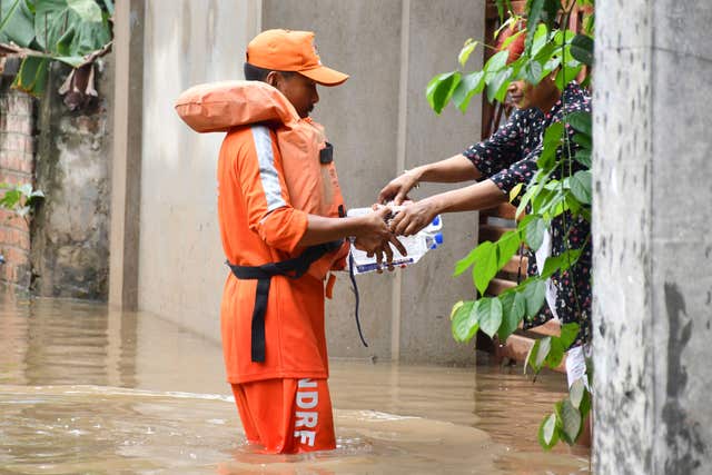 An emergency service worker distributes drinking water