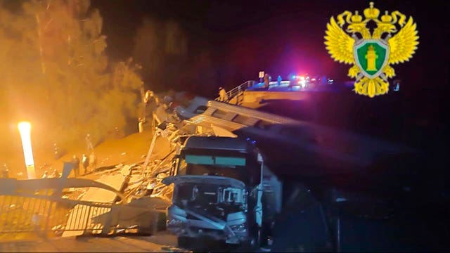 Rescue workers at a damaged bridge